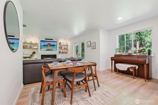 27716 NE 30th St, Redmond, WA 98053 - dining room featuring baseboards, light wood finished floors, a fireplace, french doors, and recessed lighting