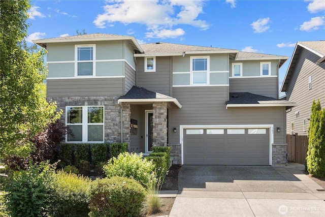 303 Vaughan Blvd NE, North Bend, WA 98045 - prairie-style home with stone siding, an attached garage, and concrete driveway