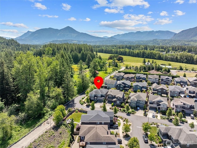 303 Vaughan Blvd NE, North Bend, WA 98045 - aerial view of residential area with a mountainous background and a forest