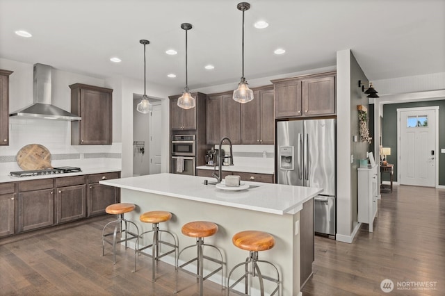 303 Vaughan Blvd NE, North Bend, WA 98045 - kitchen with stainless steel appliances, wall chimney range hood, dark wood-style floors, backsplash, and a sink