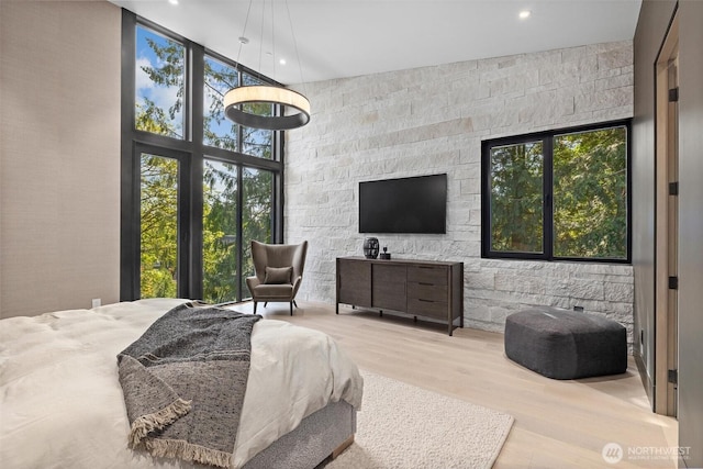 204 Northside Rd, Bellevue, WA 98004 - bedroom featuring a towering ceiling, multiple windows, wood finished floors, recessed lighting, and floor to ceiling windows