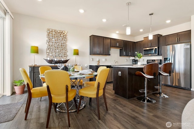6451 Randolph Dr NE, Bremerton, WA 98311 - kitchen featuring appliances with stainless steel finishes, dark brown cabinetry, dark wood-type flooring, a center island, and recessed lighting