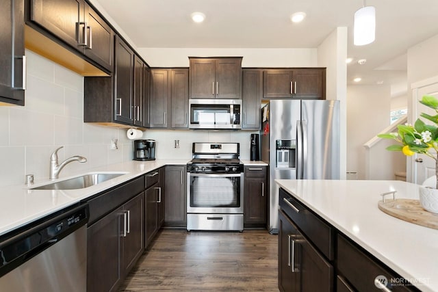 6451 Randolph Dr NE, Bremerton, WA 98311 - kitchen featuring appliances with stainless steel finishes, a sink, dark brown cabinets, light countertops, and backsplash