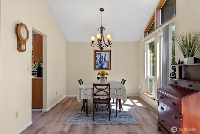 11726 130th Avenue Ct E, Puyallup, WA 98374 - dining space with a chandelier, lofted ceiling, light wood-style floors, baseboards, and a textured ceiling