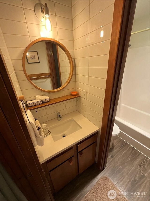 10500 Mt Baker Hwy Unit 1003, Glacier, WA 98244 - full bath featuring wood finished floors, vanity, toilet, tile walls, and shower / bathtub combination with curtain