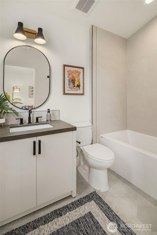 6707 117th Ave NE, Kirkland, WA 98033 - bathroom featuring toilet, vanity, a bathtub, and tile patterned floors