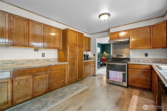 37911 300th Ave SE, Enumclaw, WA 98022 - kitchen featuring range with two ovens, under cabinet range hood, brown cabinets, and light wood-style floors