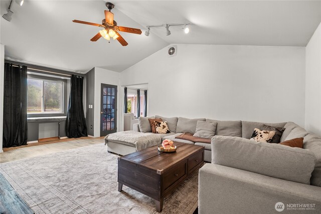 37911 300th Ave SE, Enumclaw, WA 98022 - living room featuring track lighting, vaulted ceiling, ceiling fan, and light wood-style flooring