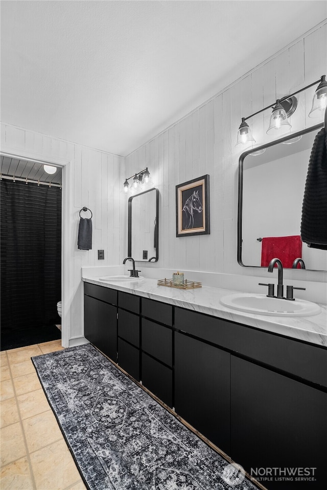 37911 300th Ave SE, Enumclaw, WA 98022 - full bathroom with double vanity, toilet, and wood walls