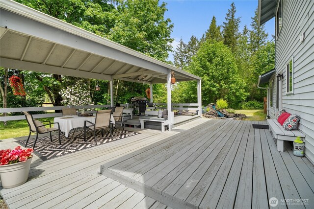 37911 300th Ave SE, Enumclaw, WA 98022 - wooden deck featuring outdoor dining space, an outdoor hangout area, and view of scattered trees