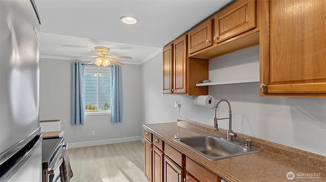 323 128th St SE Unit K120, Everett, WA 98208 - kitchen with freestanding refrigerator, a sink, electric stove, brown cabinetry, and ornamental molding
