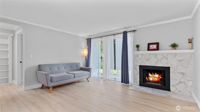 323 128th St SE Unit K120, Everett, WA 98208 - living area featuring crown molding, wood finished floors, a fireplace, and baseboards
