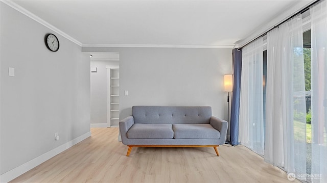 323 128th St SE Unit K120, Everett, WA 98208 - living area featuring plenty of natural light, crown molding, wood finished floors, and baseboards