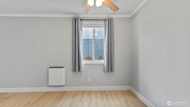 323 128th St SE Unit K120, Everett, WA 98208 - spare room with crown molding, wood finished floors, baseboards, ceiling fan, and heating unit
