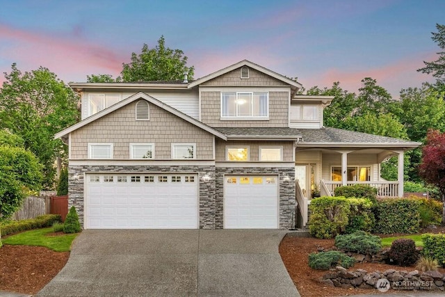 23510 14th Dr SE, Bothell, WA 98021 - view of front of property featuring driveway, a garage, stone siding, and covered porch