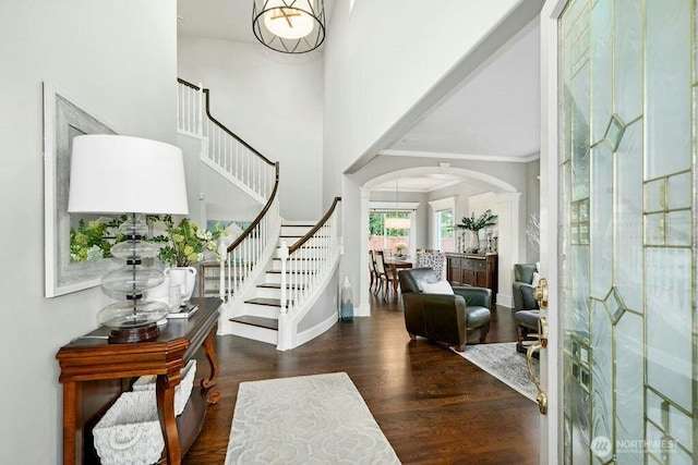 23510 14th Dr SE, Bothell, WA 98021 - foyer entrance featuring arched walkways, stairs, wood finished floors, crown molding, and baseboards