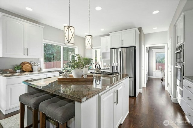 23510 14th Dr SE, Bothell, WA 98021 - kitchen featuring stainless steel appliances, a center island, dark wood-type flooring, white cabinets, and recessed lighting