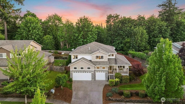 23510 14th Dr SE, Bothell, WA 98021 - view of front of property featuring stone siding, driveway, a garage, covered porch, and stairs