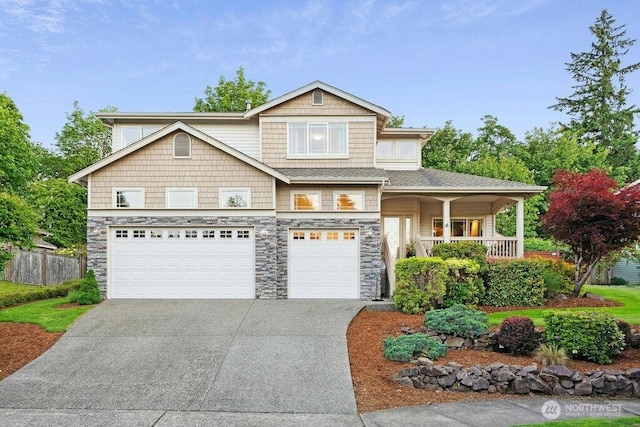 23510 14th Dr SE, Bothell, WA 98021 - view of front of house with a garage, driveway, stone siding, and covered porch