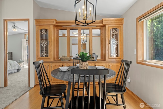 3758 Aiken Rd SE, Port Orchard, WA 98366 - dining area featuring a chandelier, lofted ceiling, light wood finished floors, and ceiling fan