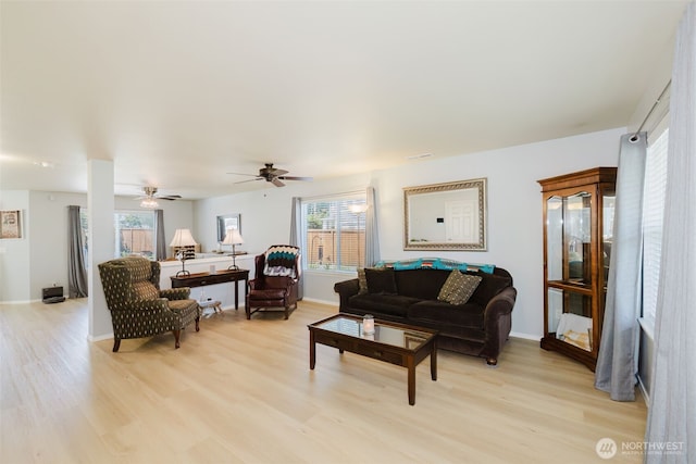 2760 SW Jabirin Way, Port Orchard, WA 98367 - living area with light wood-style floors, ceiling fan, and baseboards
