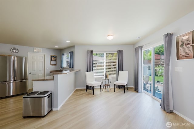2760 SW Jabirin Way, Port Orchard, WA 98367 - kitchen with freestanding refrigerator, light wood finished floors, a peninsula, baseboards, and recessed lighting
