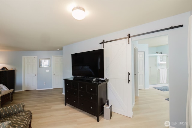 2760 SW Jabirin Way, Port Orchard, WA 98367 - living room featuring a barn door, light wood-style floors, and baseboards