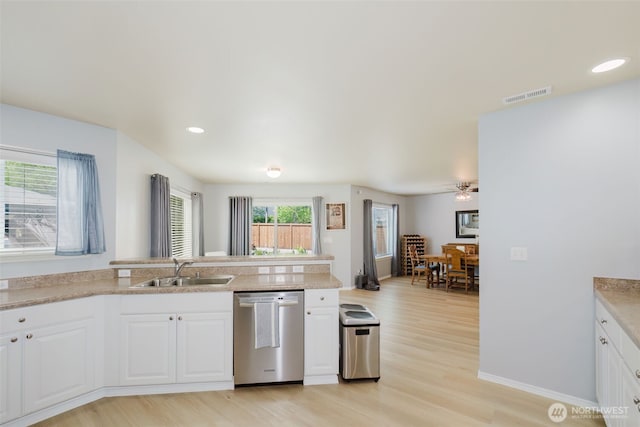 2760 SW Jabirin Way, Port Orchard, WA 98367 - kitchen with a sink, stainless steel dishwasher, light wood-type flooring, white cabinetry, and recessed lighting