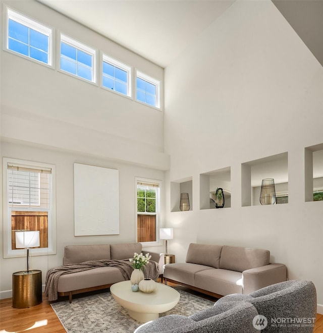 27332 SE 10th Ct, Sammamish, WA 98075 - living area with wood finished floors, a high ceiling, and baseboards