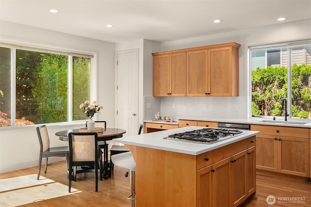 27332 SE 10th Ct, Sammamish, WA 98075 - kitchen with a sink, stainless steel gas stovetop, light countertops, light wood-style flooring, and recessed lighting