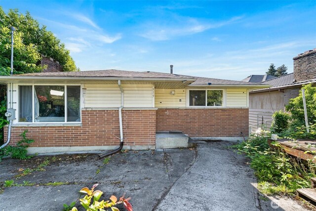7919 37th Ave S, Seattle, WA 98118 - view of front of property featuring brick siding and a chimney