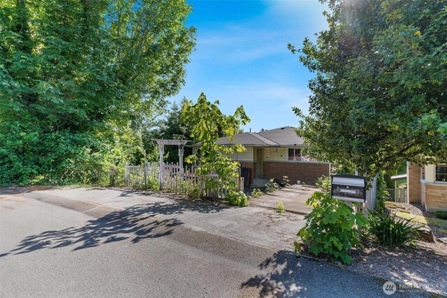 7919 37th Ave S, Seattle, WA 98118 - obstructed view of property featuring brick siding and a deck