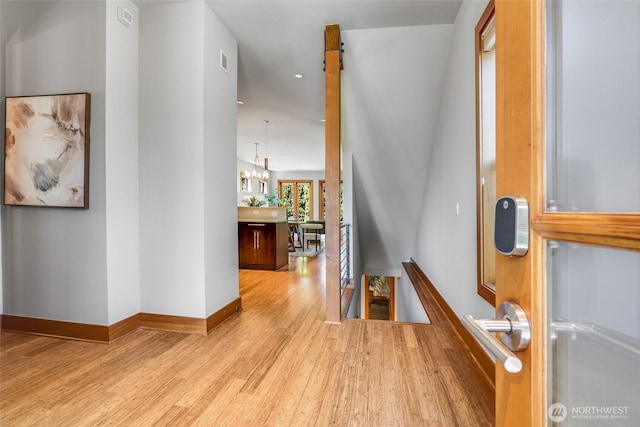 2334 N 57th St, Seattle, WA 98103 - hall with an upstairs landing, wood finished floors, a chandelier, baseboards, and recessed lighting