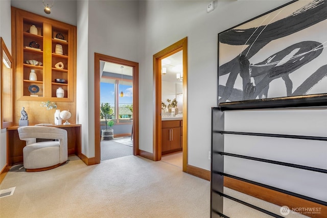 2334 N 57th St, Seattle, WA 98103 - corridor with light colored carpet, baseboards, and a desk