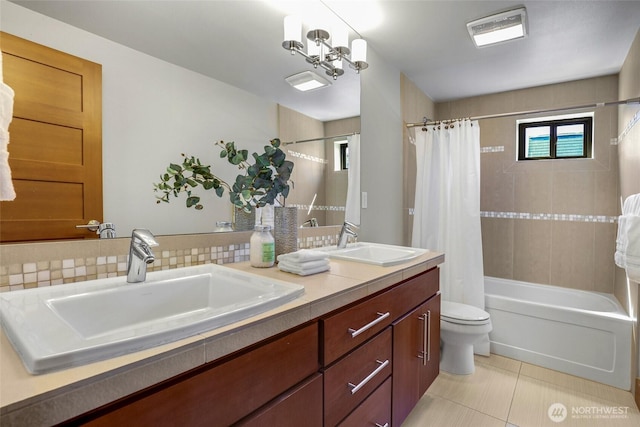 2334 N 57th St, Seattle, WA 98103 - full bathroom with double vanity, toilet, tile patterned floors, shower / bath combo, and decorative backsplash