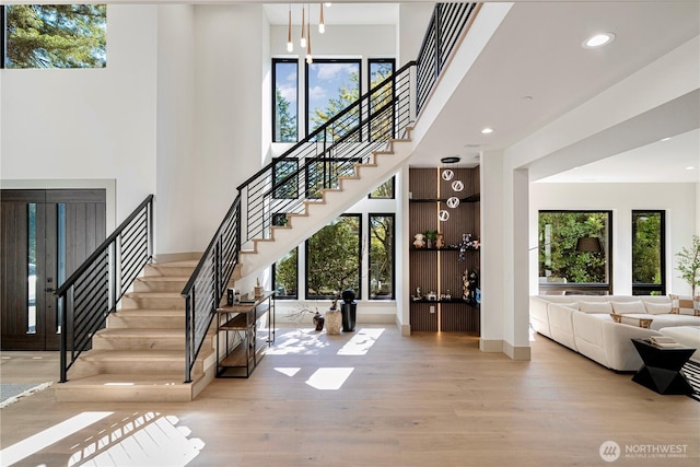 8456 SE 40th St, Mercer Island, WA 98040 - stairway with wood finished floors, plenty of natural light, recessed lighting, a high ceiling, and baseboards