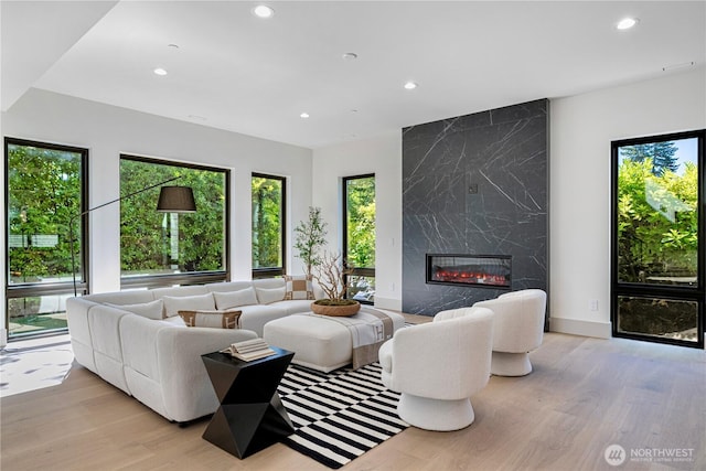 8456 SE 40th St, Mercer Island, WA 98040 - living area with light wood-style flooring, recessed lighting, a fireplace, and baseboards
