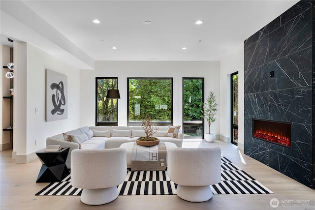 8456 SE 40th St, Mercer Island, WA 98040 - living room with recessed lighting, an accent wall, a premium fireplace, wood finished floors, and baseboards