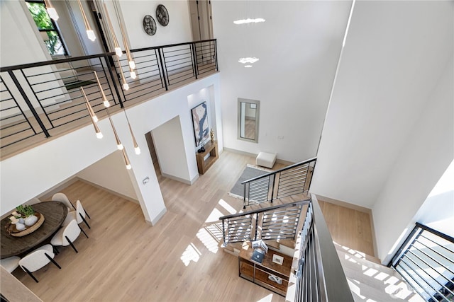8456 SE 40th St, Mercer Island, WA 98040 - staircase with wood finished floors, a towering ceiling, and baseboards