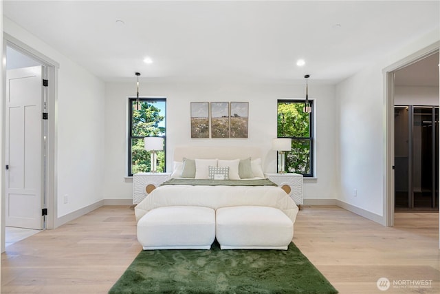 8456 SE 40th St, Mercer Island, WA 98040 - bedroom with light wood-type flooring, multiple windows, a walk in closet, and recessed lighting