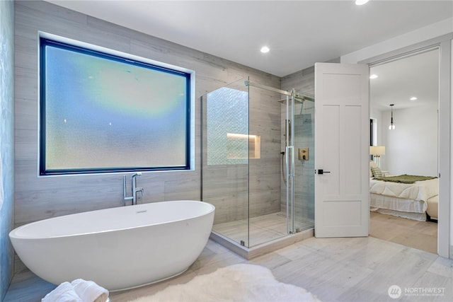 8456 SE 40th St, Mercer Island, WA 98040 - ensuite bathroom featuring a soaking tub, a stall shower, recessed lighting, healthy amount of natural light, and wood finished floors