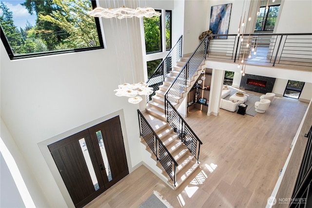 8456 SE 40th St, Mercer Island, WA 98040 - stairs with a towering ceiling, a chandelier, healthy amount of natural light, wood finished floors, and a high end fireplace