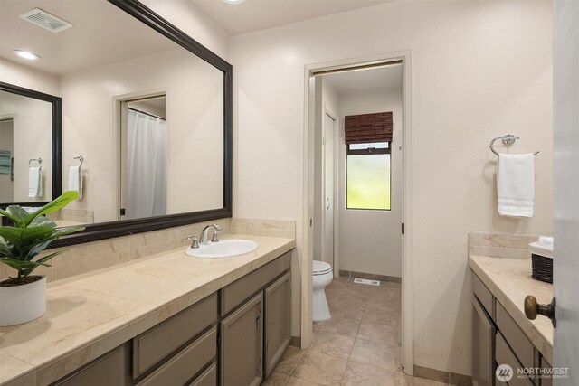 2911 216th Ave NE, Sammamish, WA 98074 - full bath with double vanity, toilet, and tile patterned flooring
