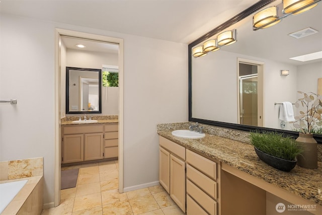 2911 216th Ave NE, Sammamish, WA 98074 - full bathroom featuring a shower stall, vanity, a garden tub, baseboards, and a skylight
