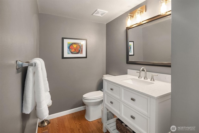 2911 216th Ave NE, Sammamish, WA 98074 - bathroom featuring vanity, wood finished floors, toilet, and baseboards
