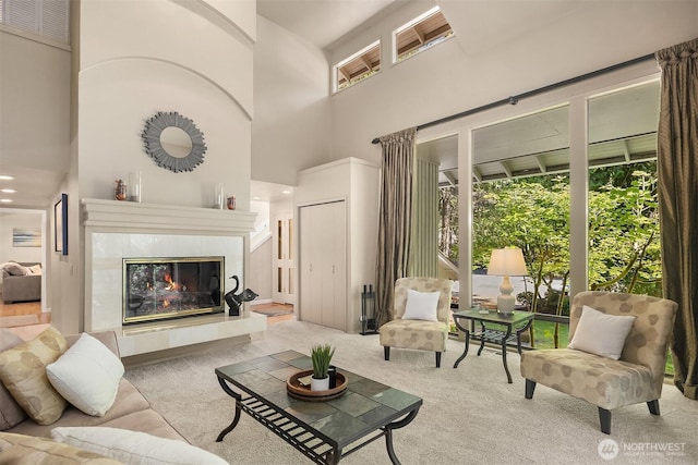 2911 216th Ave NE, Sammamish, WA 98074 - living area featuring a high ceiling, carpet floors, and a tiled fireplace