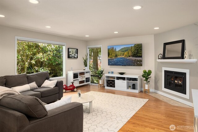 2911 216th Ave NE, Sammamish, WA 98074 - living room with recessed lighting, a lit fireplace, and light wood-style floors