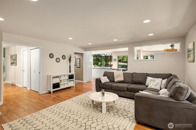 2911 216th Ave NE, Sammamish, WA 98074 - living room featuring light wood finished floors, recessed lighting, and baseboards