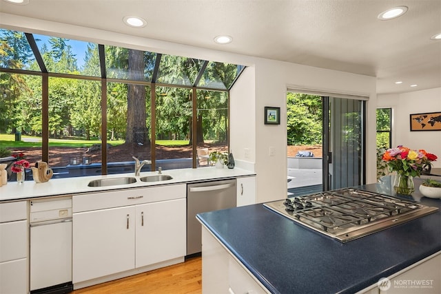 2911 216th Ave NE, Sammamish, WA 98074 - kitchen featuring stainless steel appliances, a sink, white cabinets, recessed lighting, and light wood finished floors