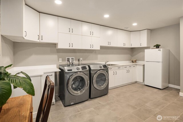 2911 216th Ave NE, Sammamish, WA 98074 - laundry room featuring washing machine and dryer, cabinet space, recessed lighting, and light tile patterned flooring